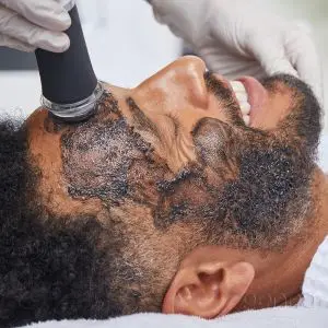 happy man during glo2facial treament