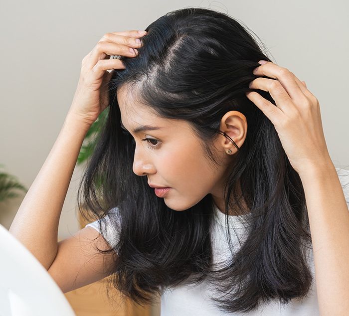 woman with thinning hair considering hair transplants and alternatives in Cleveland