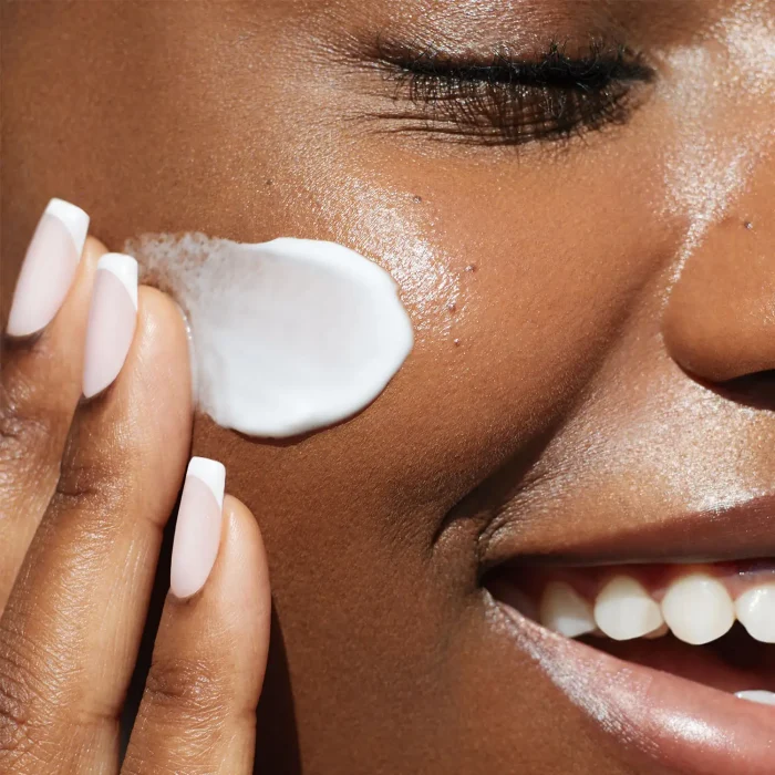 woman with beautiful skin applying medical grade skincare products