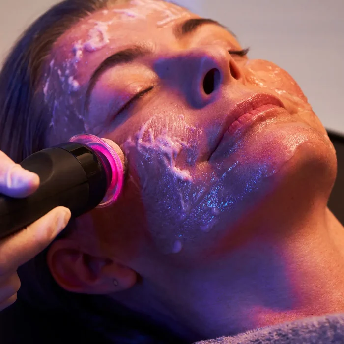 woman enjoying Glo2Facial an October Special at NuIQ