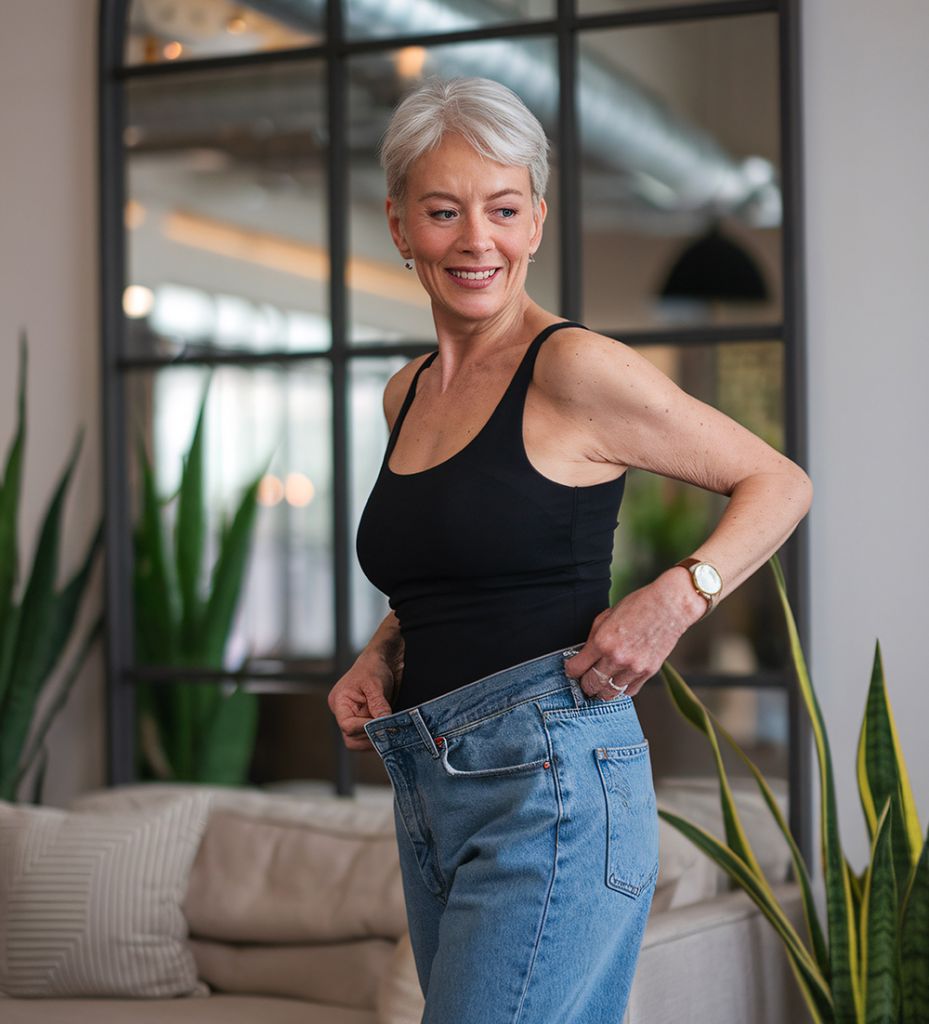 woman trying on pants after successful weight loss