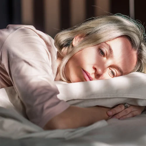 woman in bed affected by sleep disruption